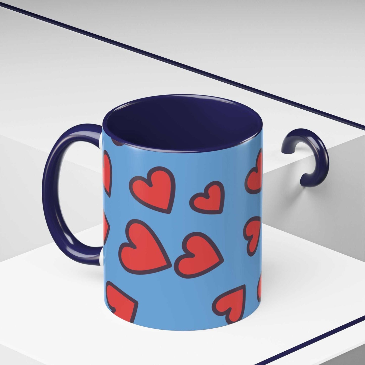 Vibrant Love Accent Coffee Mug with blue exterior and red heart pattern, dark handle and interior, microwave and dishwasher safe