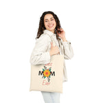 Woman carrying a Best Mom Ever cotton canvas tote bag with floral design