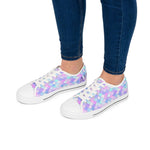 Women's pastel mermaid print low top sneakers with white toe caps and laces worn with dark blue jeans