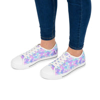 Women's pastel mermaid print low top sneakers with white toe caps and laces worn with dark blue jeans