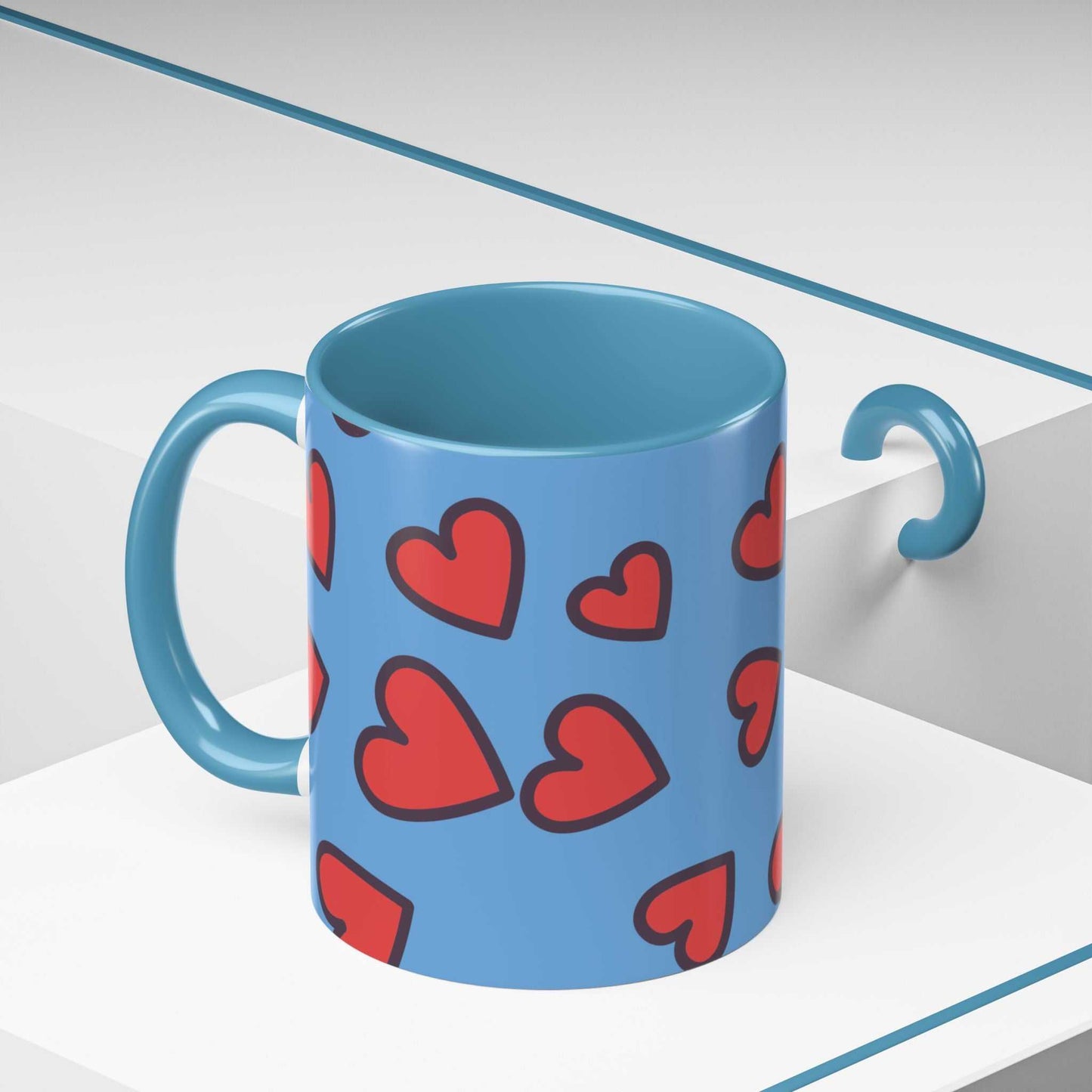 Blue ceramic coffee mug with red heart accents and handle, vibrant love accent coffee mug design