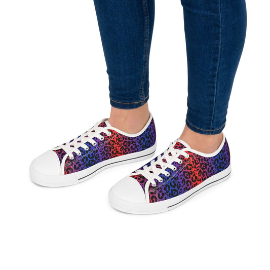 Colorful leopard print women's low top sneakers with white soles and laces worn with jeans