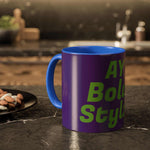 Colorful custom mug with blue handle and interior, purple exterior, green bold text, on kitchen countertop