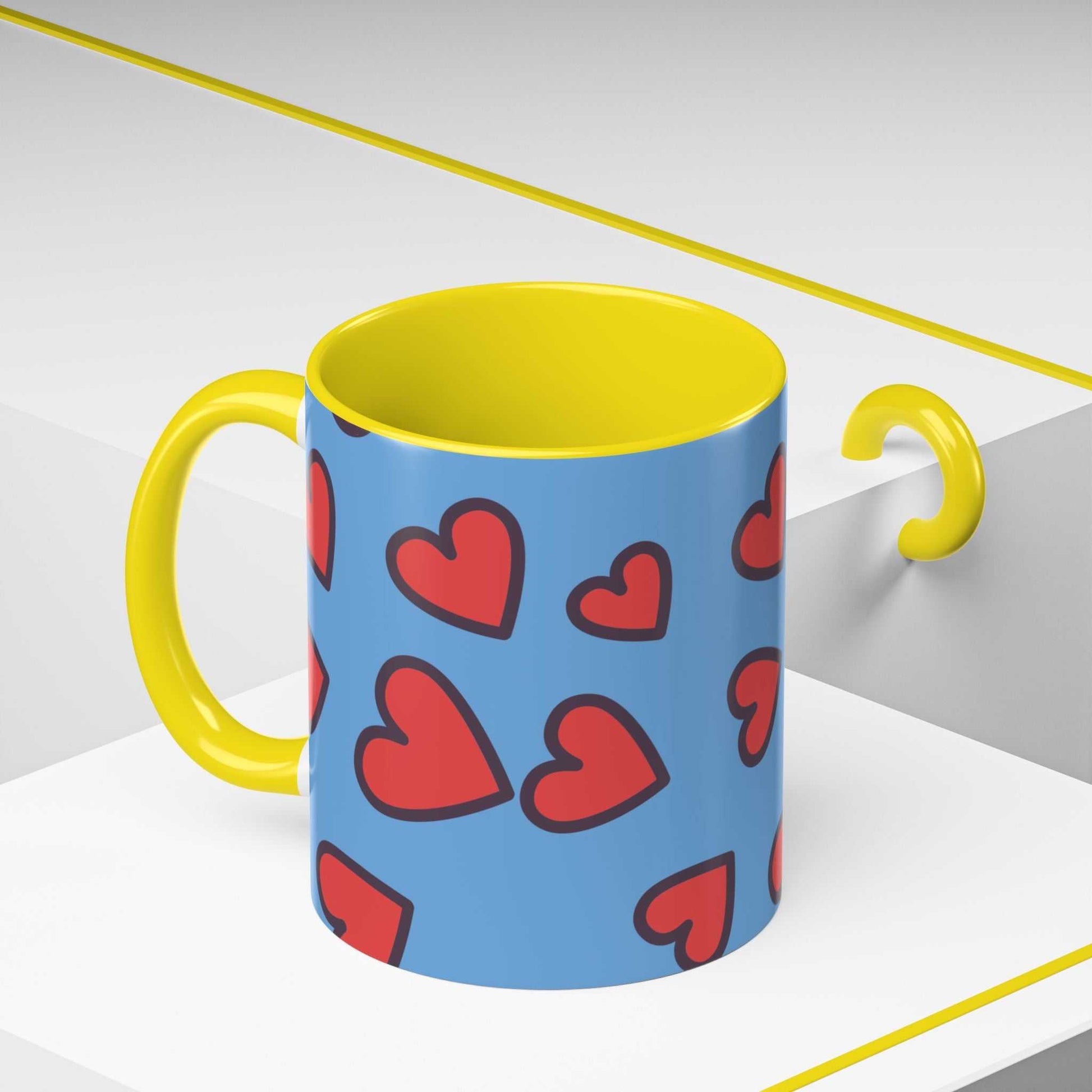 Vibrant Love Accent Coffee Mug with yellow handle and interior and red heart pattern on blue background