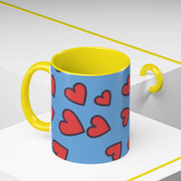 Vibrant Love Accent Coffee Mug with yellow handle and interior and red heart pattern on blue background