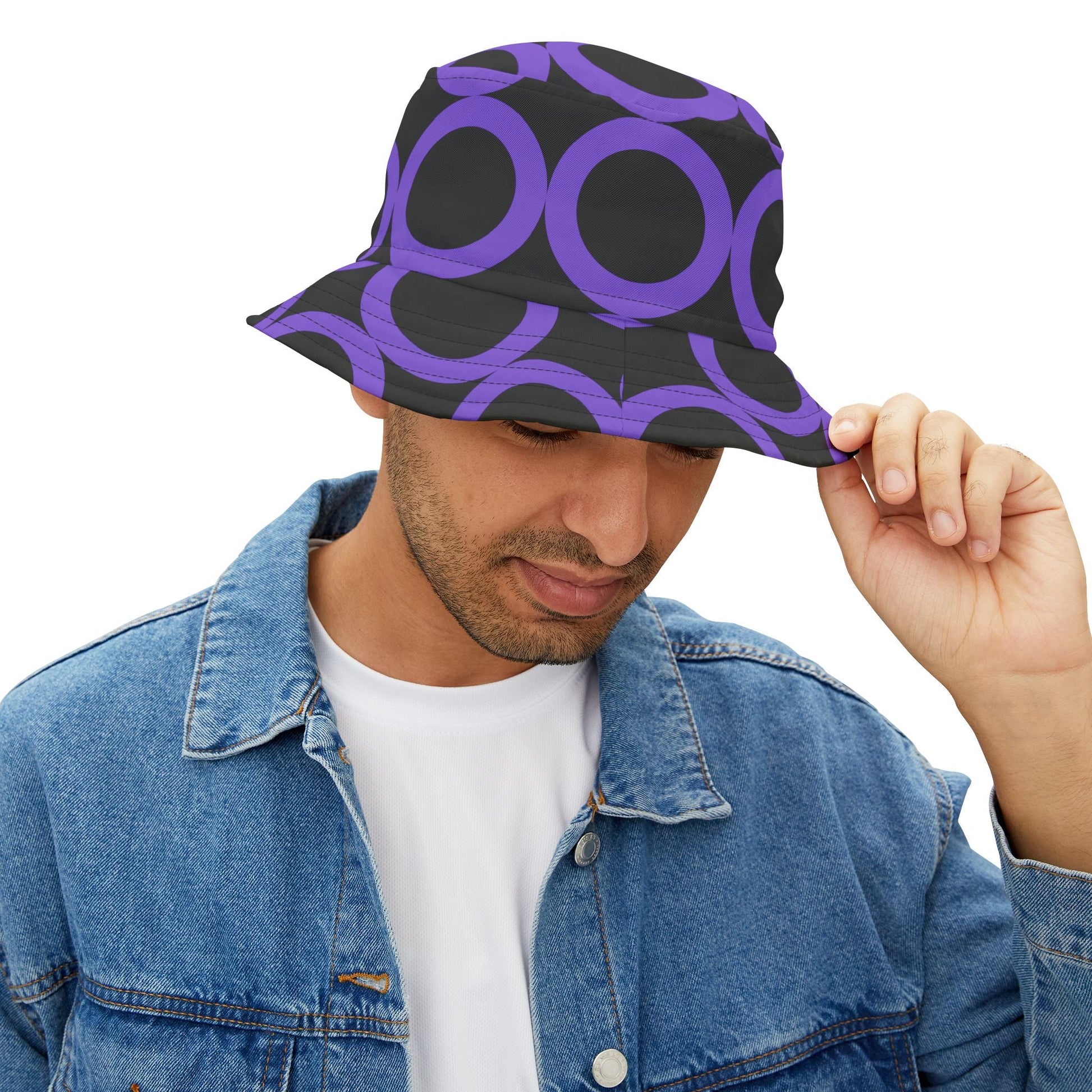 Man wearing purple dot pattern bucket hat with black background and denim jacket