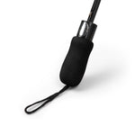 Foldable umbrella with black rubber handle and wrist strap on white background