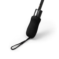 Foldable umbrella with black rubber handle and wrist strap on white background
