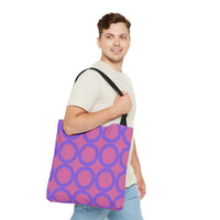 Chic light pink and purple circle tote bag worn by man with black handles