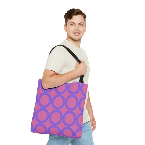 Chic light pink and purple circle tote bag worn by man with black handles