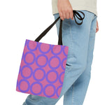 Chic Light Pink & Purple Circle Tote Bag with black handles carried by a person wearing blue jeans and a beige top