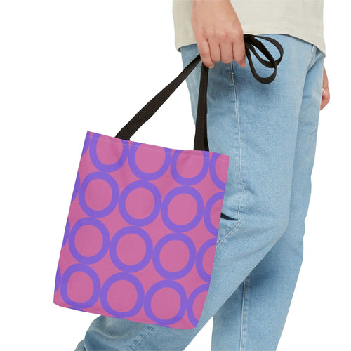 Chic Light Pink & Purple Circle Tote Bag with black handles carried by a person wearing blue jeans and a beige top