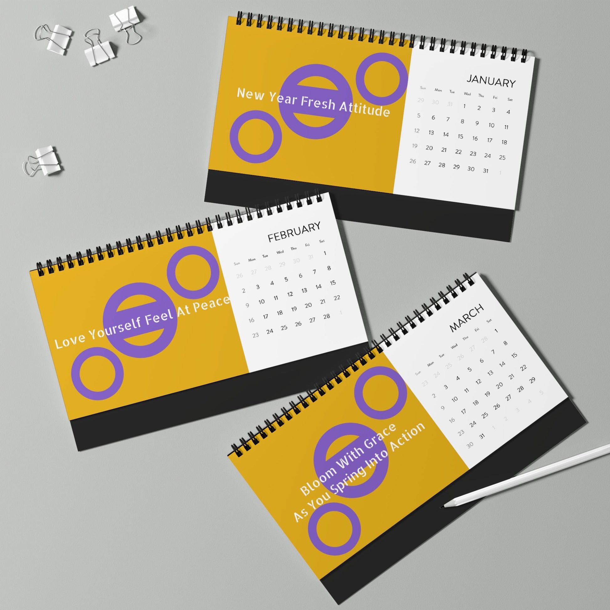 2025 desktop calendar with spiral binding showing January, February, and March months with motivational quotes and yellow accents