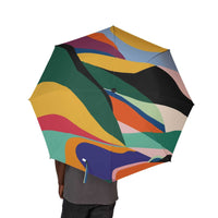 Colorful foldable umbrella with abstract pattern, compact and lightweight for travel and rain protection