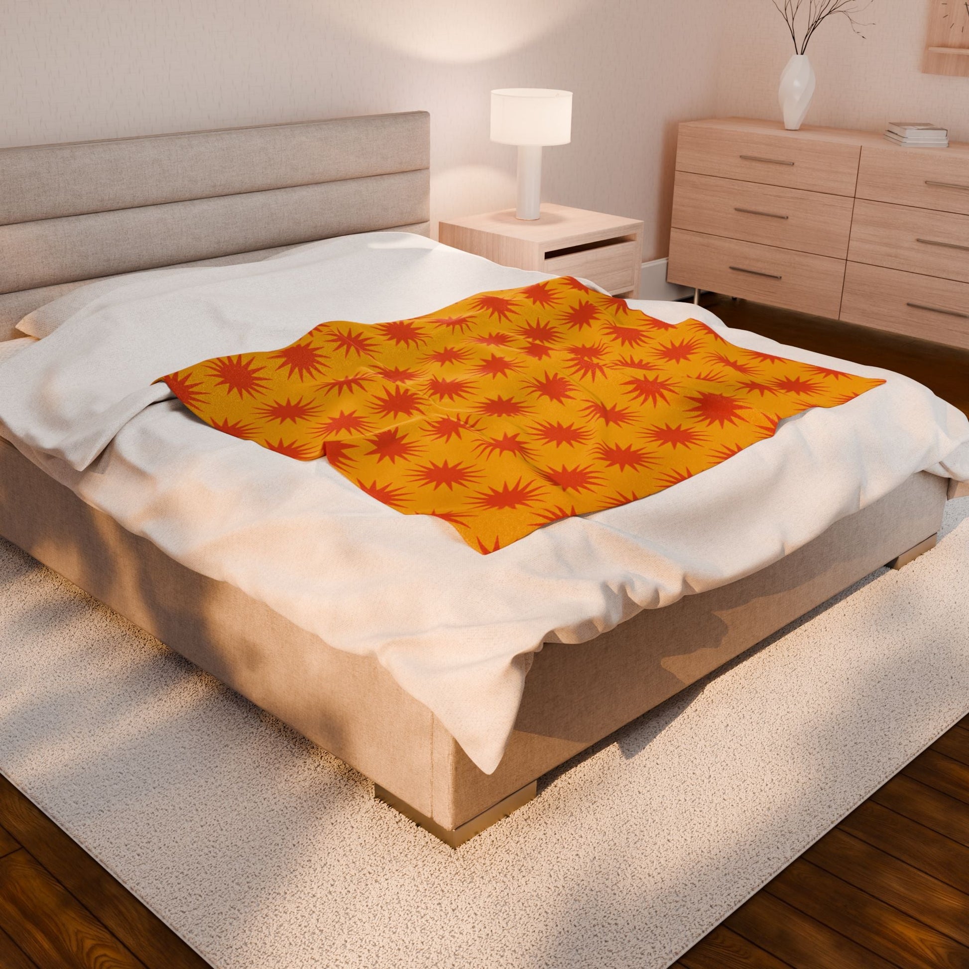 Cozy Velveteen Plush Blanket with vibrant orange and red print on bed in modern bedroom setting