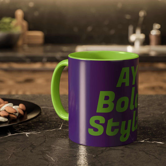 Colorful custom mug with purple exterior and green interior, bold text design, glossy ceramic finish, kitchen countertop background