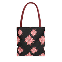 Colorful AOP Tote Bag with pink floral design on black background and maroon handles, reusable shopping bag