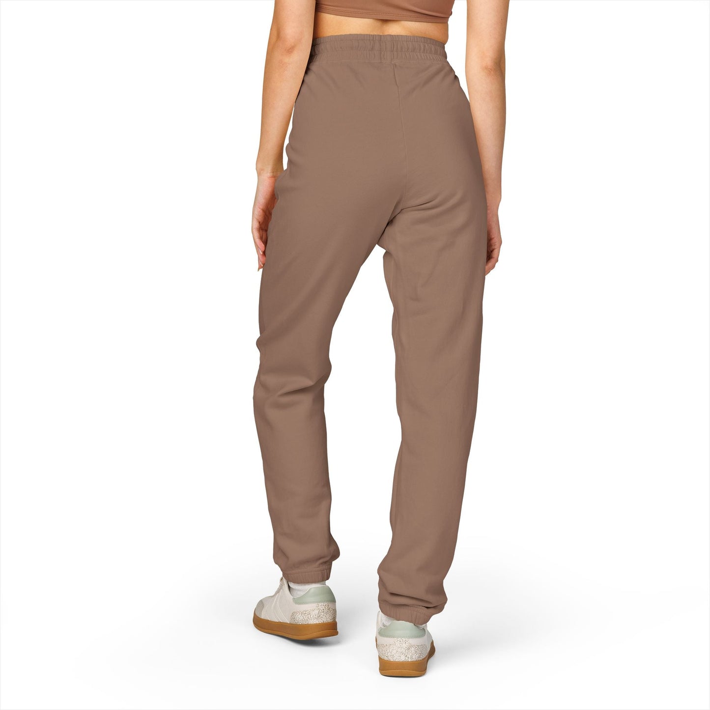 comfortable unisex fleece sweatpants in brown with relaxed fit and elastic waistband worn by person from back view
