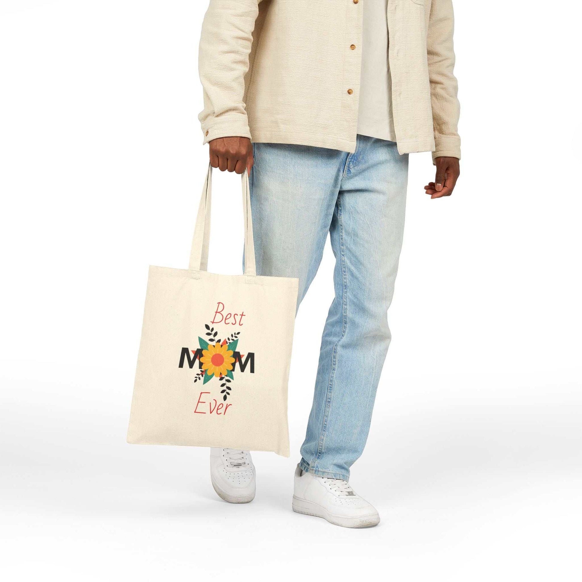 Best Mom Ever cotton canvas tote bag with floral design carried by person wearing beige shirt and jeans